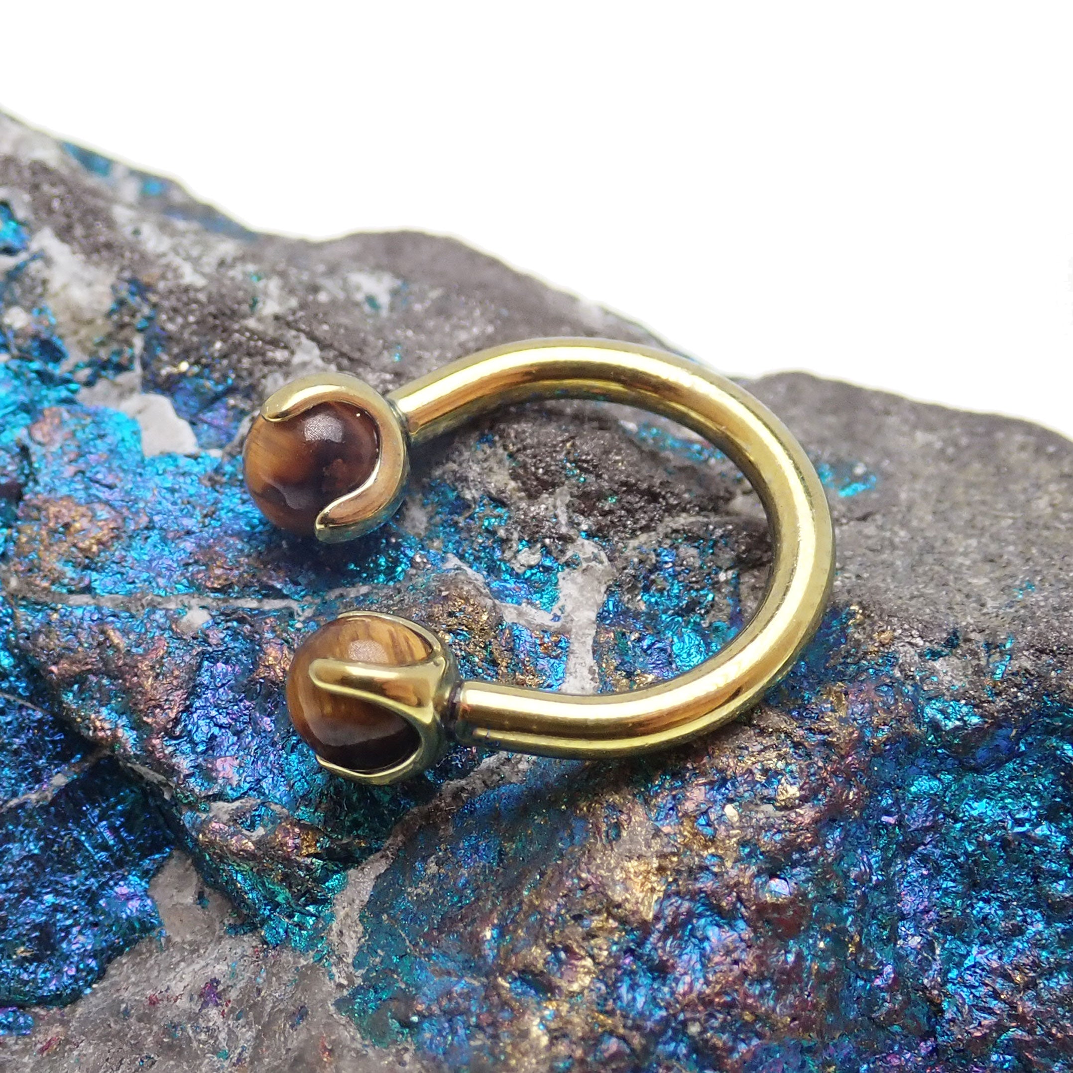 16g Tiger's Eye horseshoe body jewelry by Body Clickers, featuring polished tiger's eye stones and a horseshoe shape.