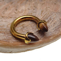 Titanium circular tiger's eye body jewelry in 14g with 8mm diameter, featuring a polished tiger's eye stone setting.