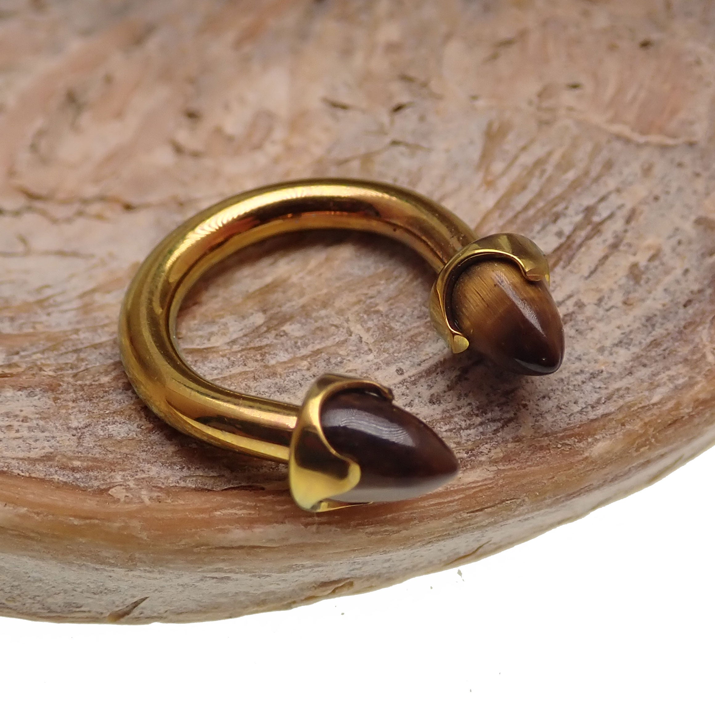 Titanium circular tiger's eye body jewelry in 14g with 8mm diameter, featuring a polished tiger's eye stone setting.