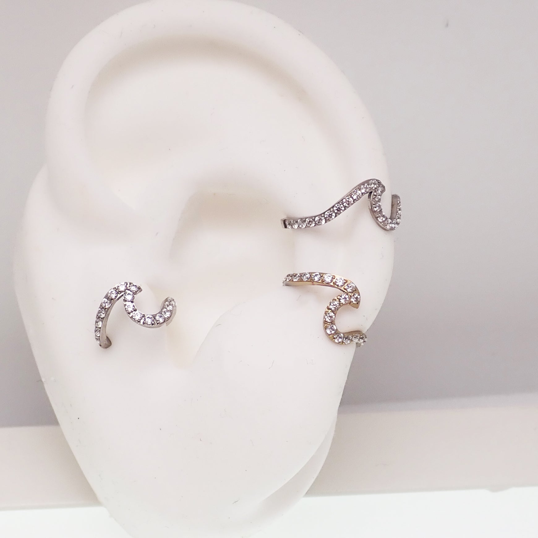Titanium Wave & CZ Clicker body jewelry in 16g with 8mm wave design by Body Clickers, featuring sparkling cubic zirconia accents.
