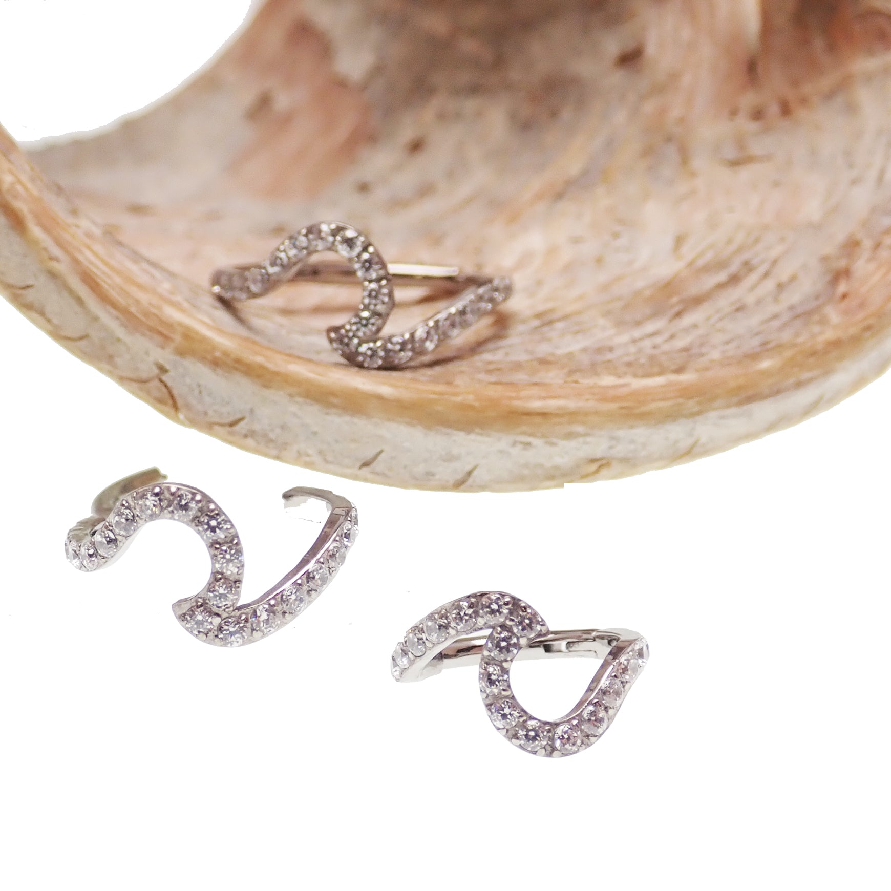 Titanium Wave and CZ clicker body jewelry in 16g, featuring a sleek wave design with sparkling cubic zirconia accents.