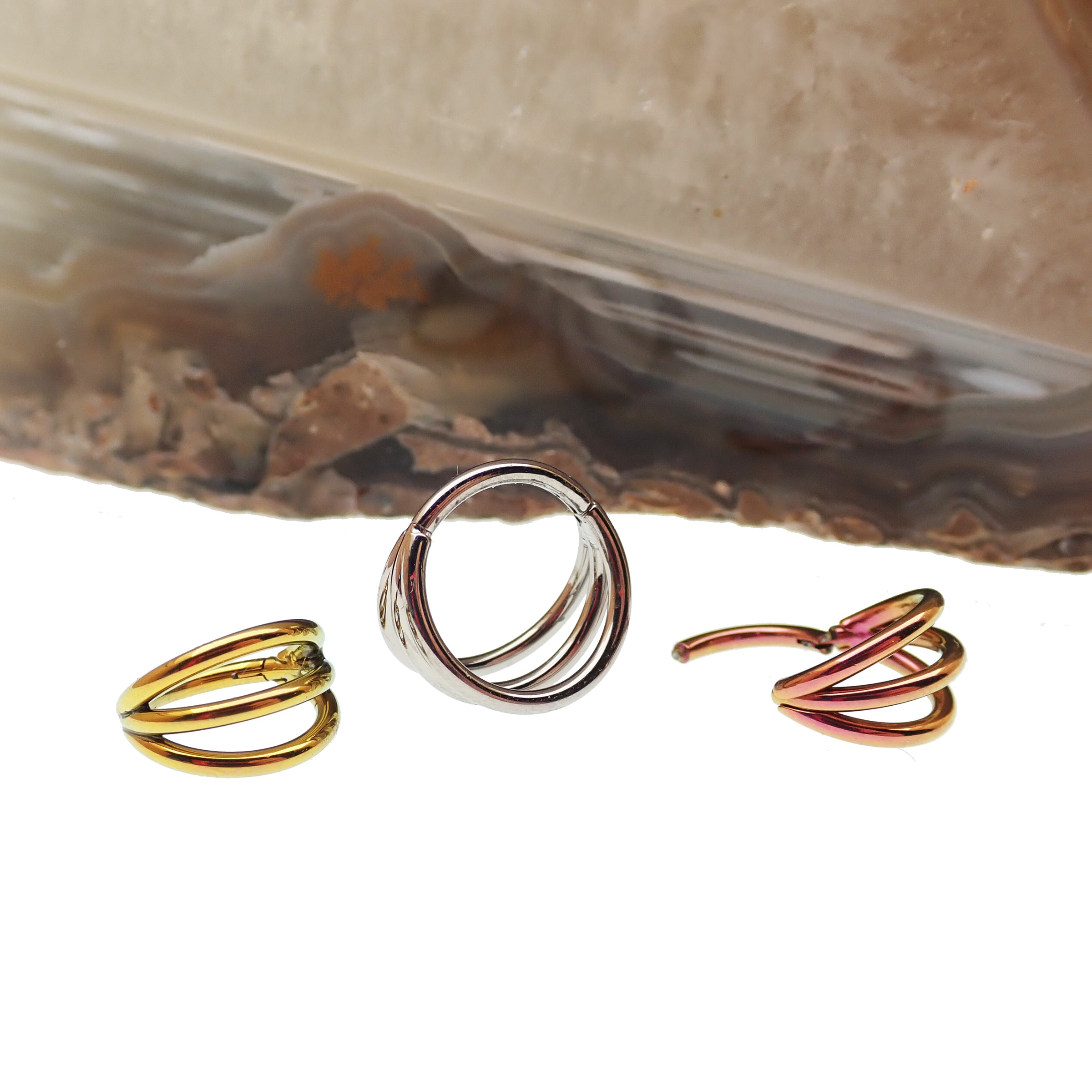 Tri-Hoop Titanium Clicker body jewelry with 8mm diameter and 16g gauge, featuring a sleek, modern design by Body Clickers.
