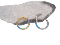 Tri-Opal inlaid titanium clicker body jewelry in 16g with 8mm diameter, featuring a sleek design and vibrant opal accents.