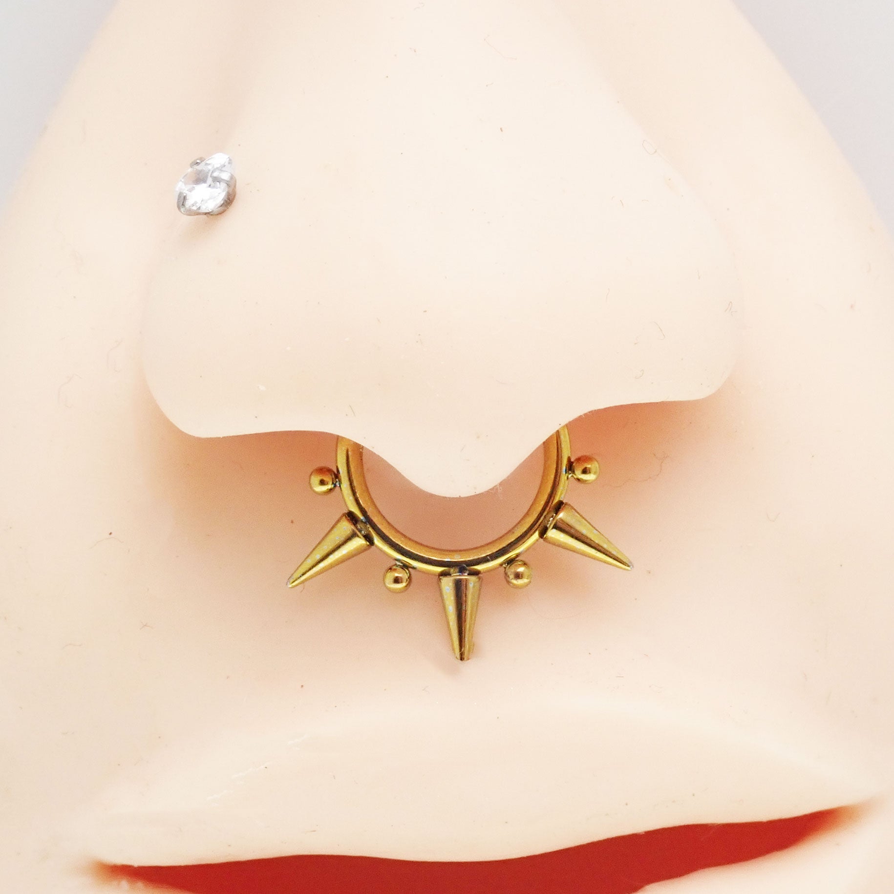 Beaded septum clicker with tri-spiked design in 16g body jewelry, featuring beaded accents and a sleek, silver finish