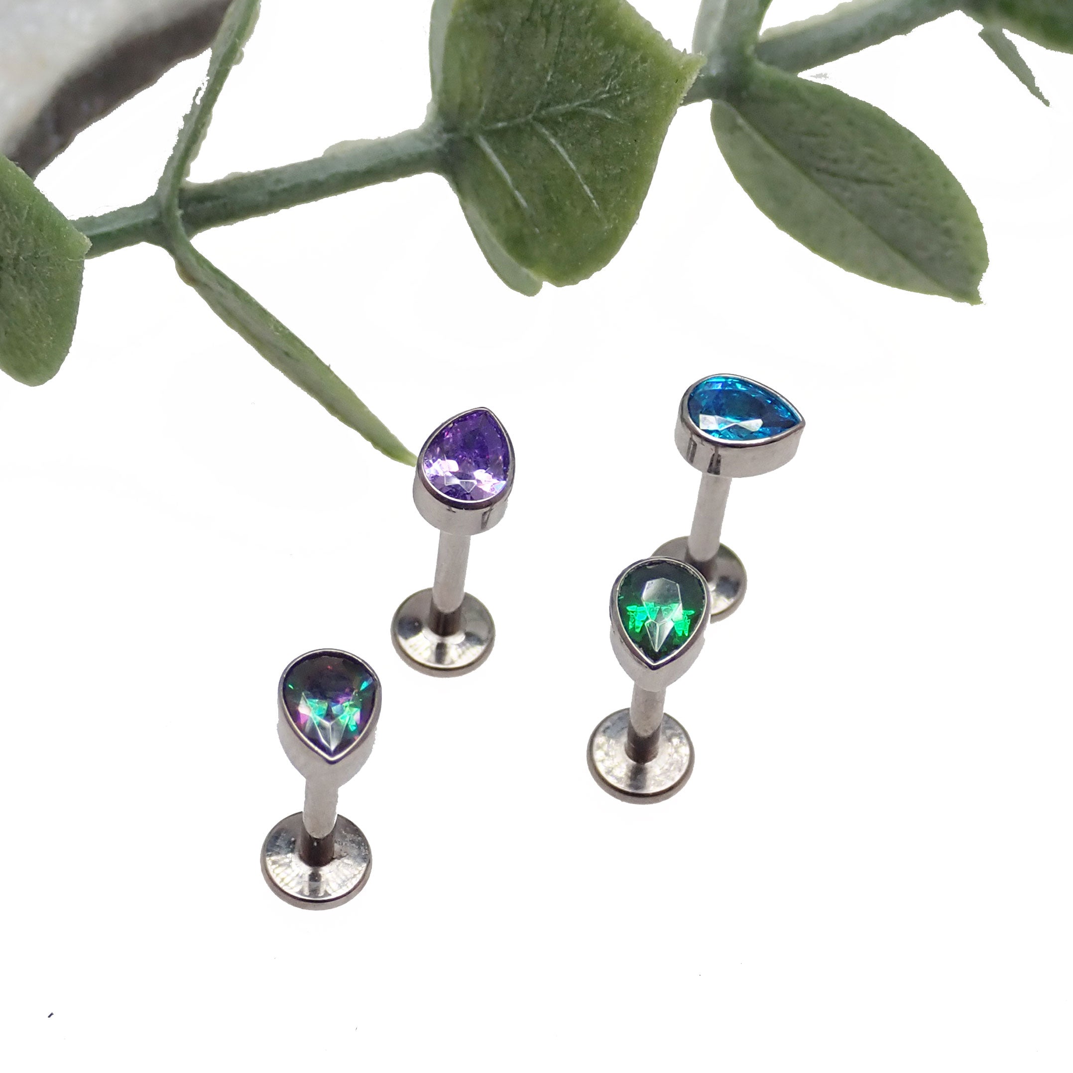 Medusa piercing with a silver CZ teardrop flat back body jewelry by Body Clickers in 14g, 16g, or 18g sizes.