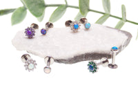 Azure blue flower and flat-top opal CZ body jewelry pair, 14g internally threaded body clickers with 6mm stones.