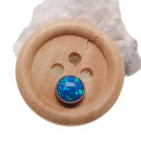 Peacock blue cabochon opal top body jewelry by Body Clickers, showcasing a smooth, polished gemstone for piercings.
