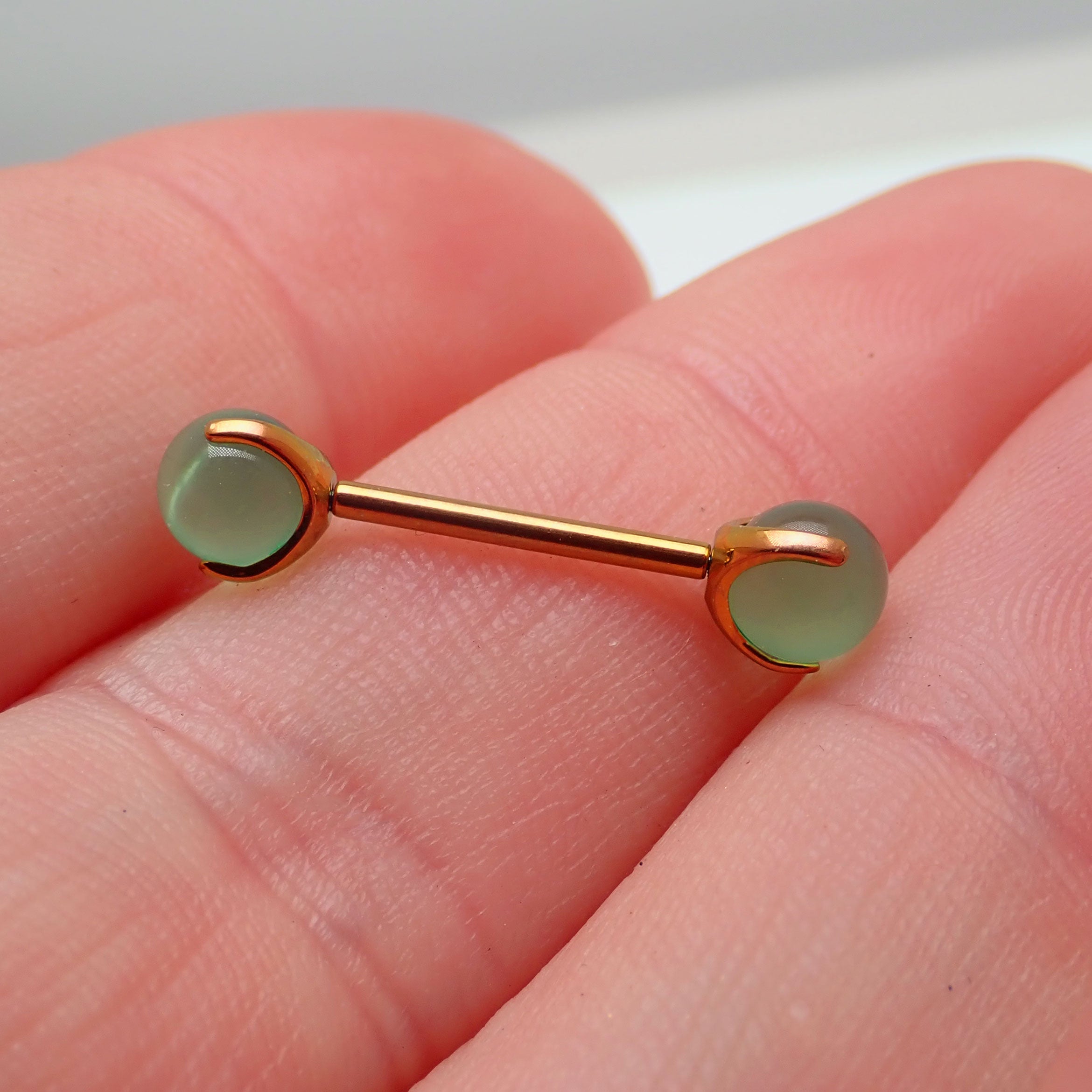Jade titanium barbell piercing in 12g or 14g with 12mm length, Body Clickers Body Jewelry, featuring a smooth jade stone and sleek design.