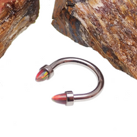 Black horseshoe body jewelry with 3mm spiked opal cone ends in 16g, featuring a curved design and bold style.