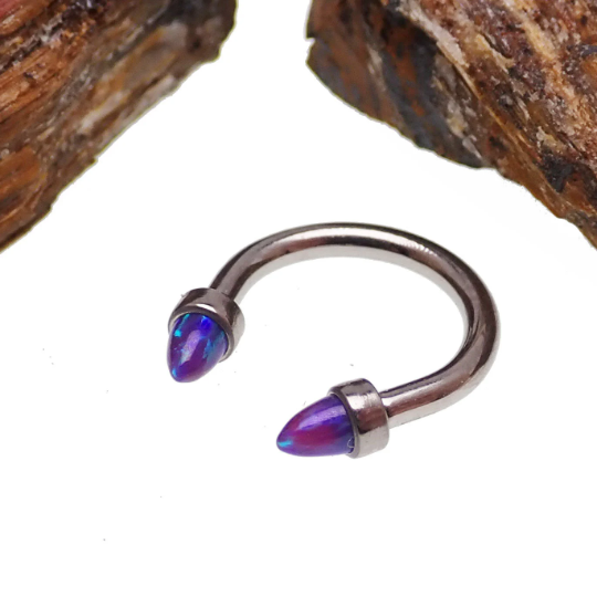 Black horseshoe body jewelry with 16g gauge, featuring 3mm spiked opal cone ends, ideal for piercings.