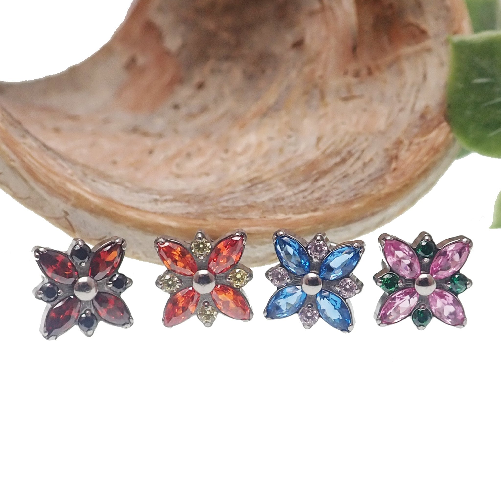 Blue and light pink flower bloom CZ body jewelry in flatback design, available in 14g, 16g, and 18g sizes from Body Clickers.