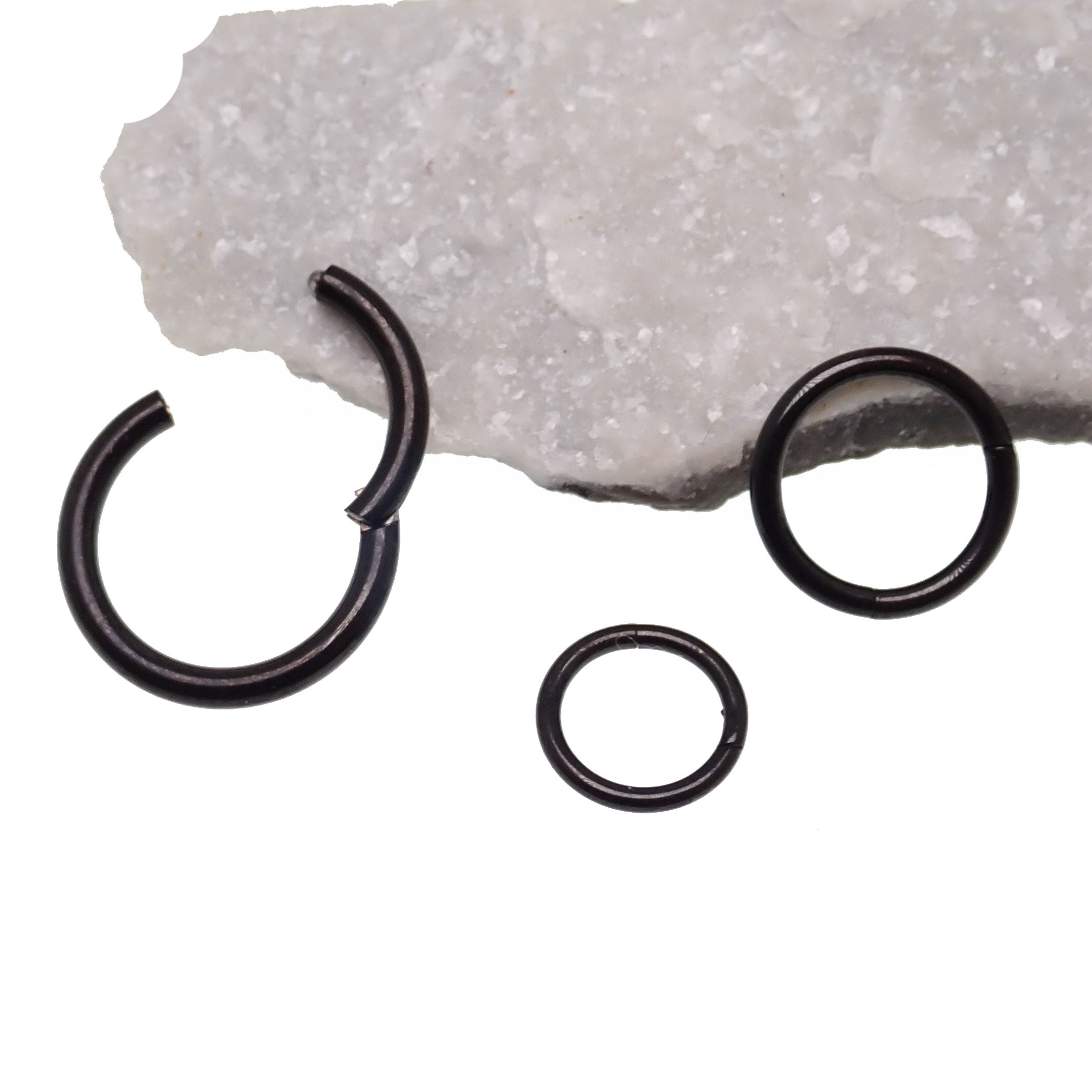 Plain PVD black hinged clicker piercing in 18g body jewelry, featuring a sleek, minimalist design with a hinged closure.