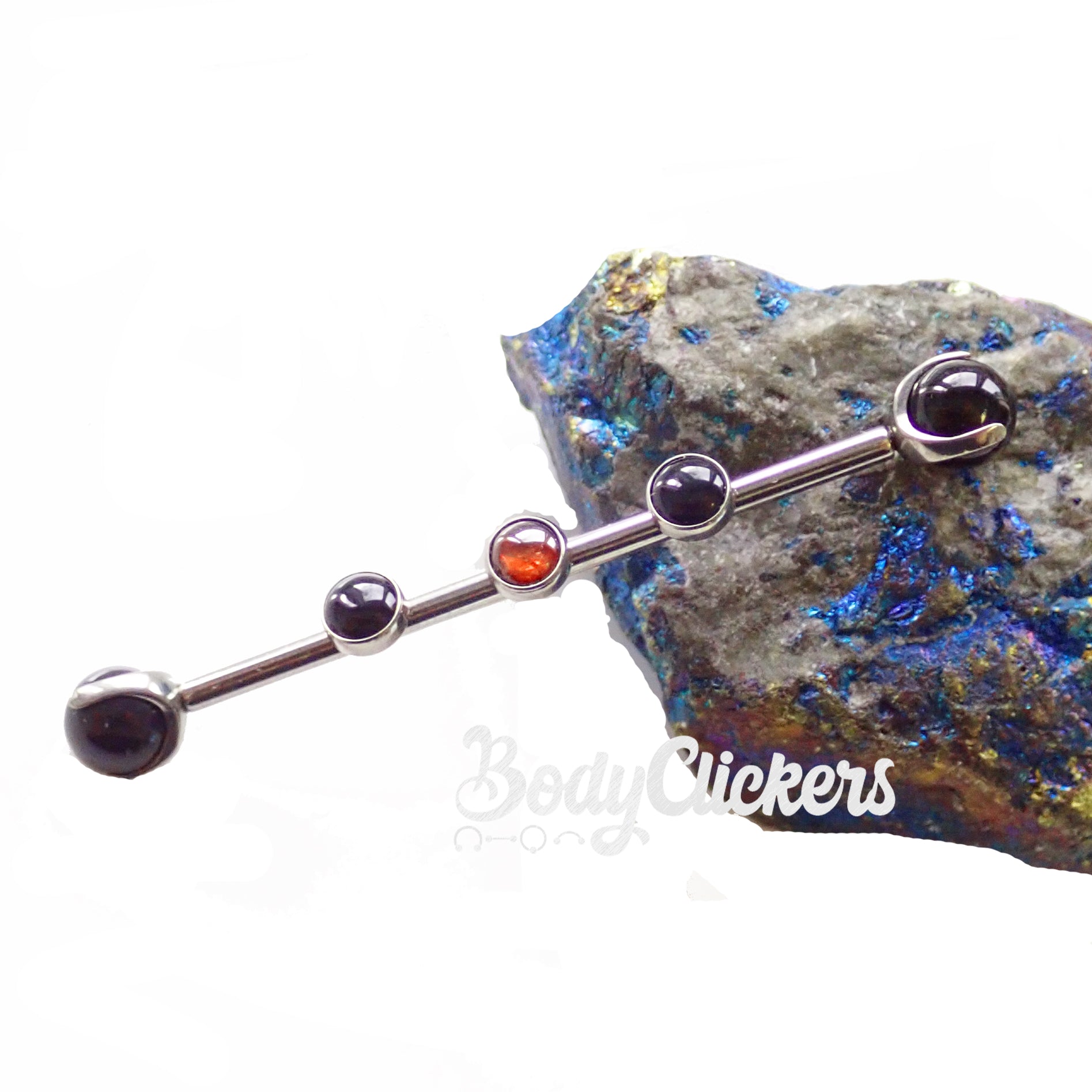 Onyx and garnet titanium industrial body jewelry by Body Clickers, 14g, with black onyx and red garnet stones.