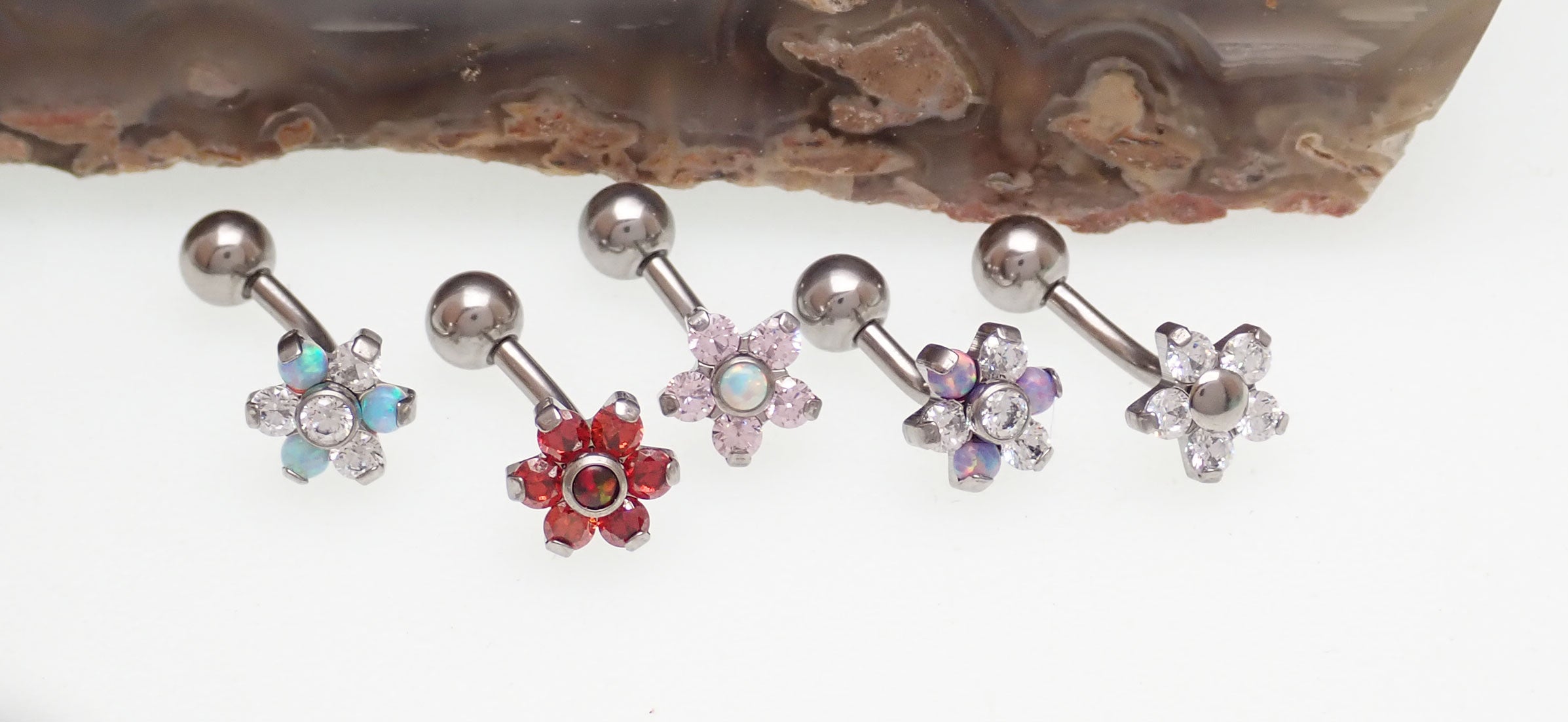 Opal flower curved barbell body jewelry, 16g, with clear CZ stones, from Body Clickers Body Jewelry, showing the decorative floral design.