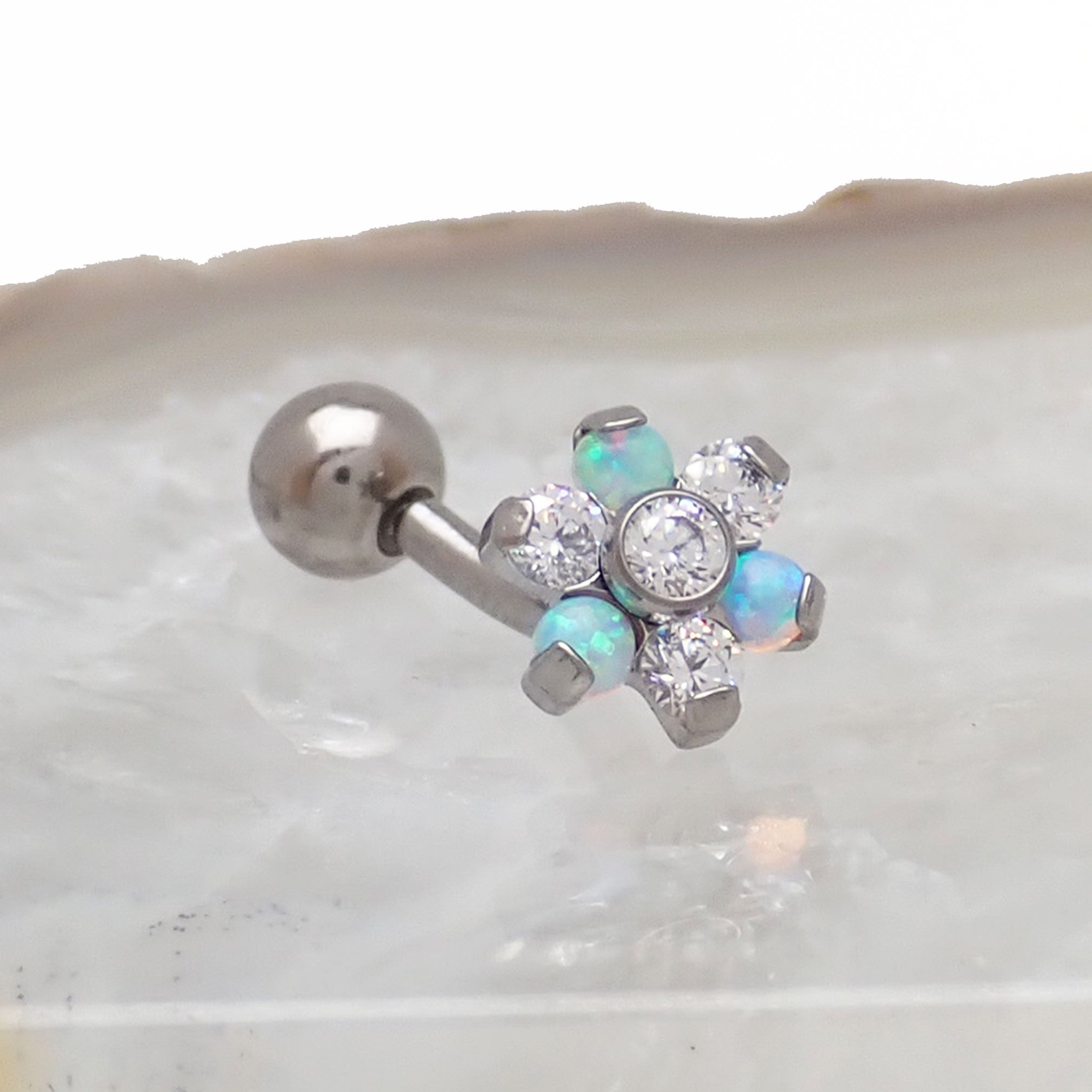Clear CZ opal flower curved barbell body jewelry in 16g, featuring a floral design and curved shape for piercing embellishment.