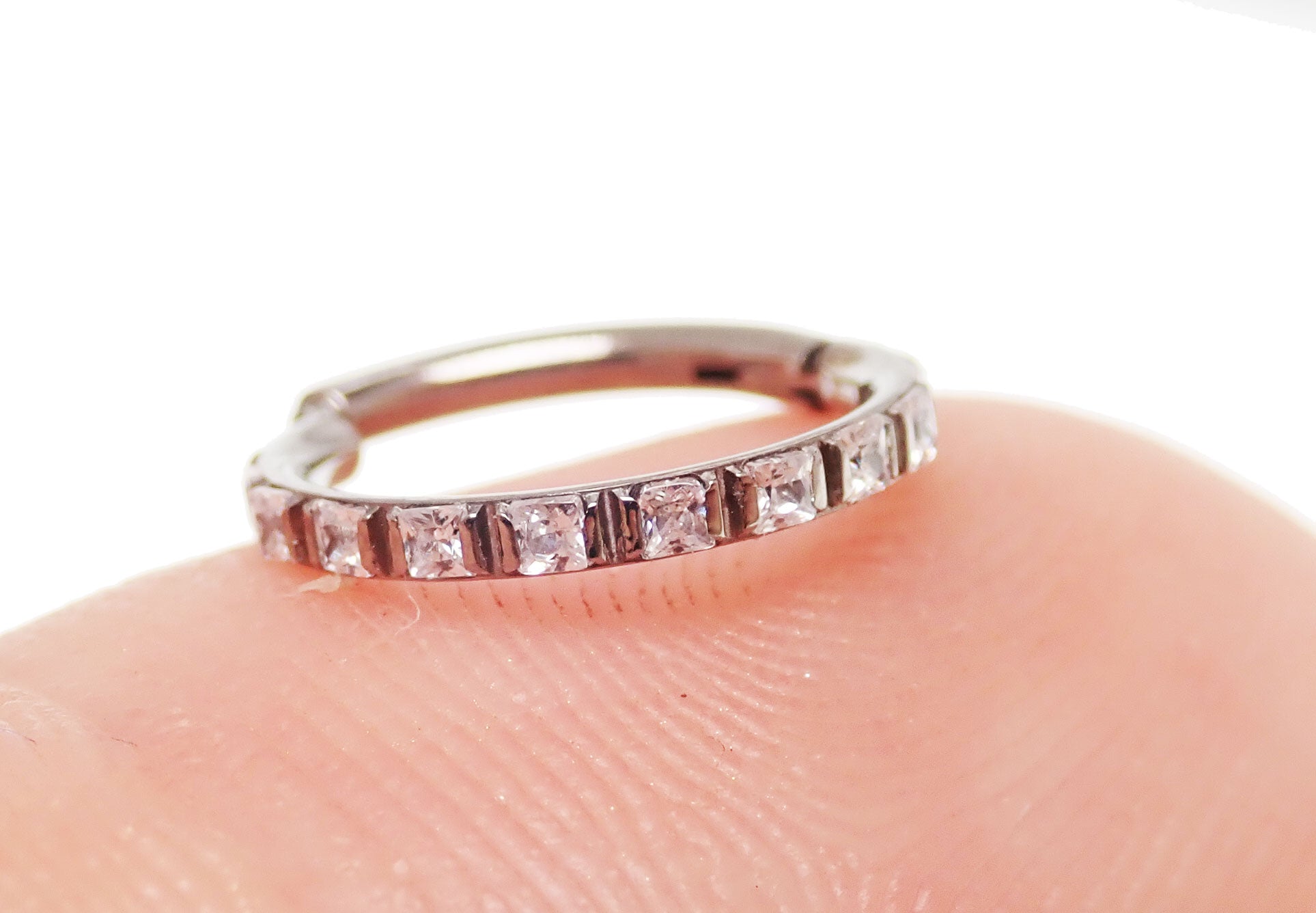 Square crystals titanium clicker body jewelry in 16g with 6mm crystals, featuring a sleek and modern design.