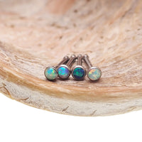 Set of four opal nose bone titanium studs for body jewelry, featuring sparkling opal stones and sleek titanium posts.