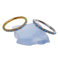 Side-facing turquoise and CZ alternating clicker body jewelry in 18g, featuring turquoise stones and sparkling cubic zirconia.