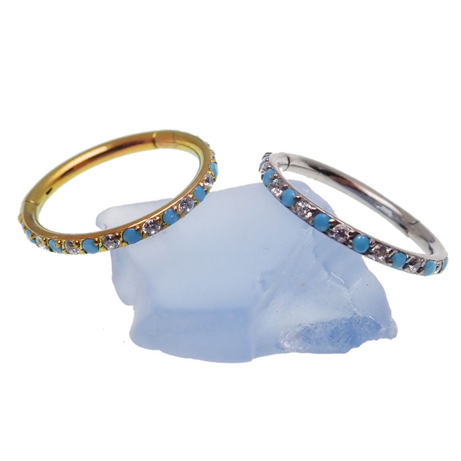 Side-facing turquoise and CZ alternating clicker body jewelry in 18g, featuring turquoise stones and sparkling cubic zirconia.