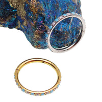 Side-facing turquoise and CZ alternating clicker body jewelry in 18g with sleek design and sparkling stones.