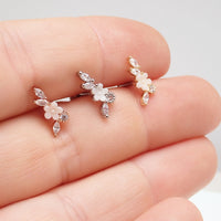 Brass helix flower body piercing with CZ stones, 16g, showing detailed floral design and sparkling gemstone accents.