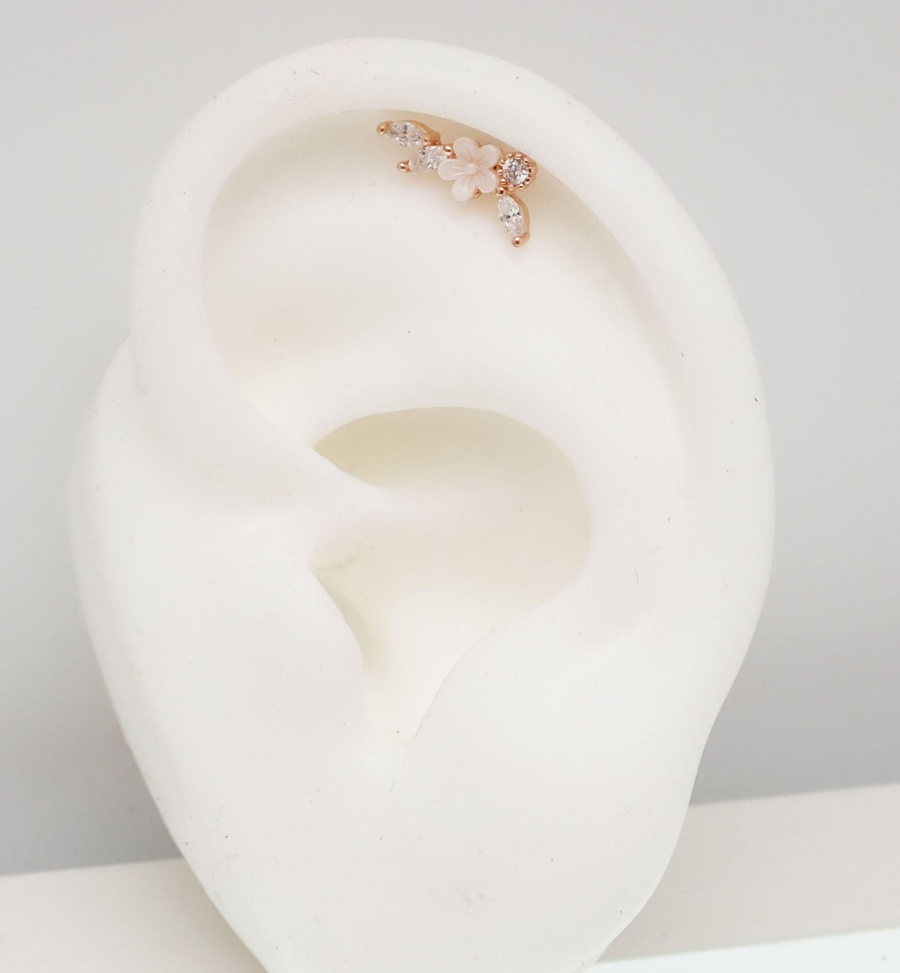 Brass helix flower body jewelry with CZ stones, 16g piercing, featuring a decorative steel flower design for ear piercings.