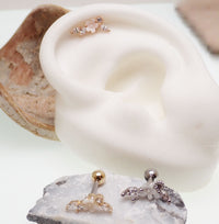 Brass helix flower body jewelry with CZ stones, 16g piercing, featuring a steel and brass design with floral and gemstone details.