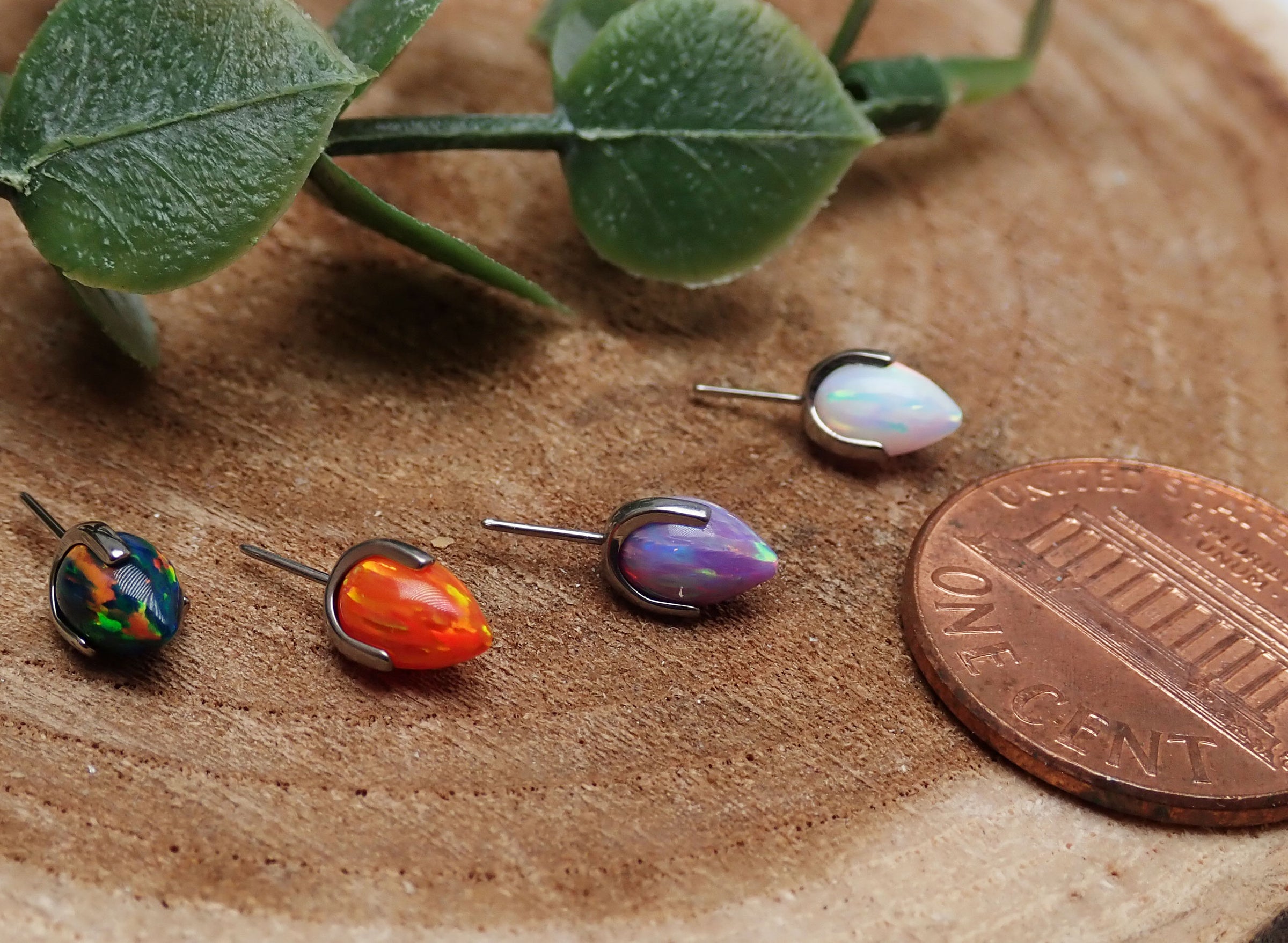Orange push fit bullet opal ends for body jewelry by Body Clickers, featuring smooth bullet shape and vibrant opal design.