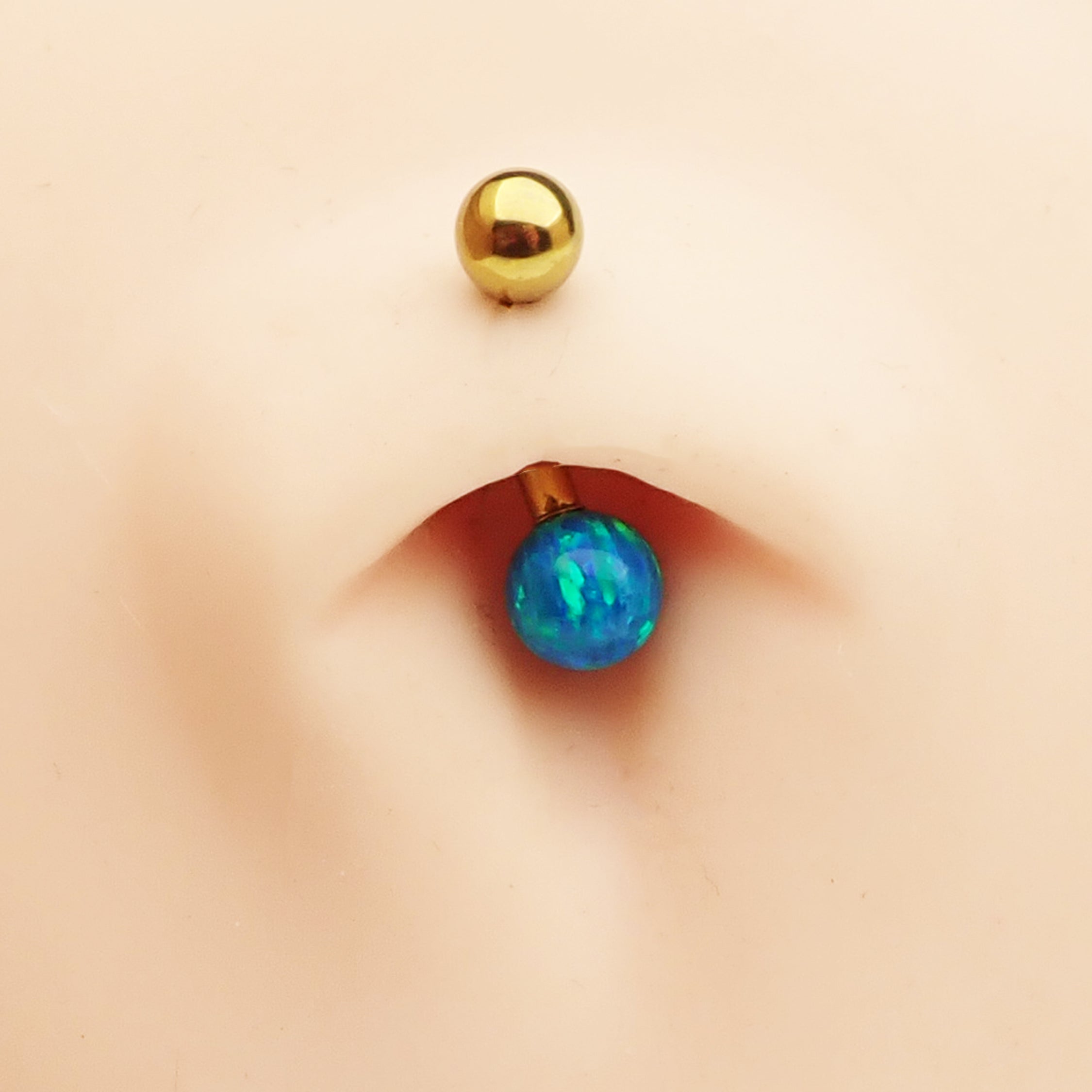 Curved titanium belly piercing with a 6mm pink opal gemstone, 14g body jewelry by Body Clickers.