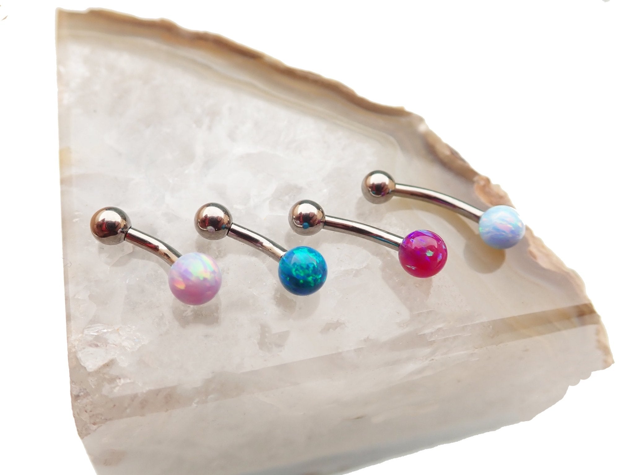 Curved titanium belly piercing with 6mm opal in bubblegum pink, 14g body jewelry by Body Clickers.