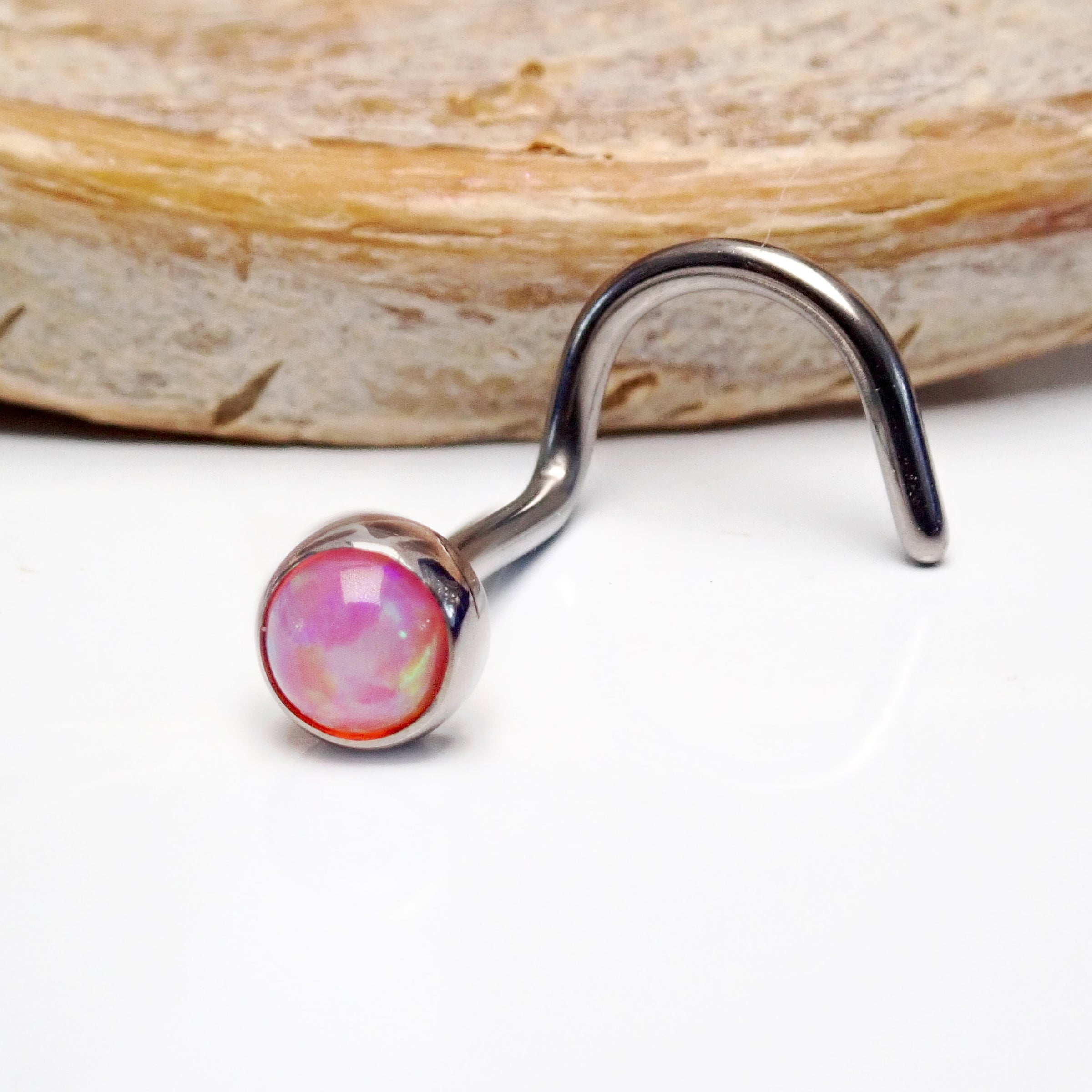 Body Clickers Opal Nose Curl 20g body jewelry with pink bubblegum opal design, suitable for pierced noses.