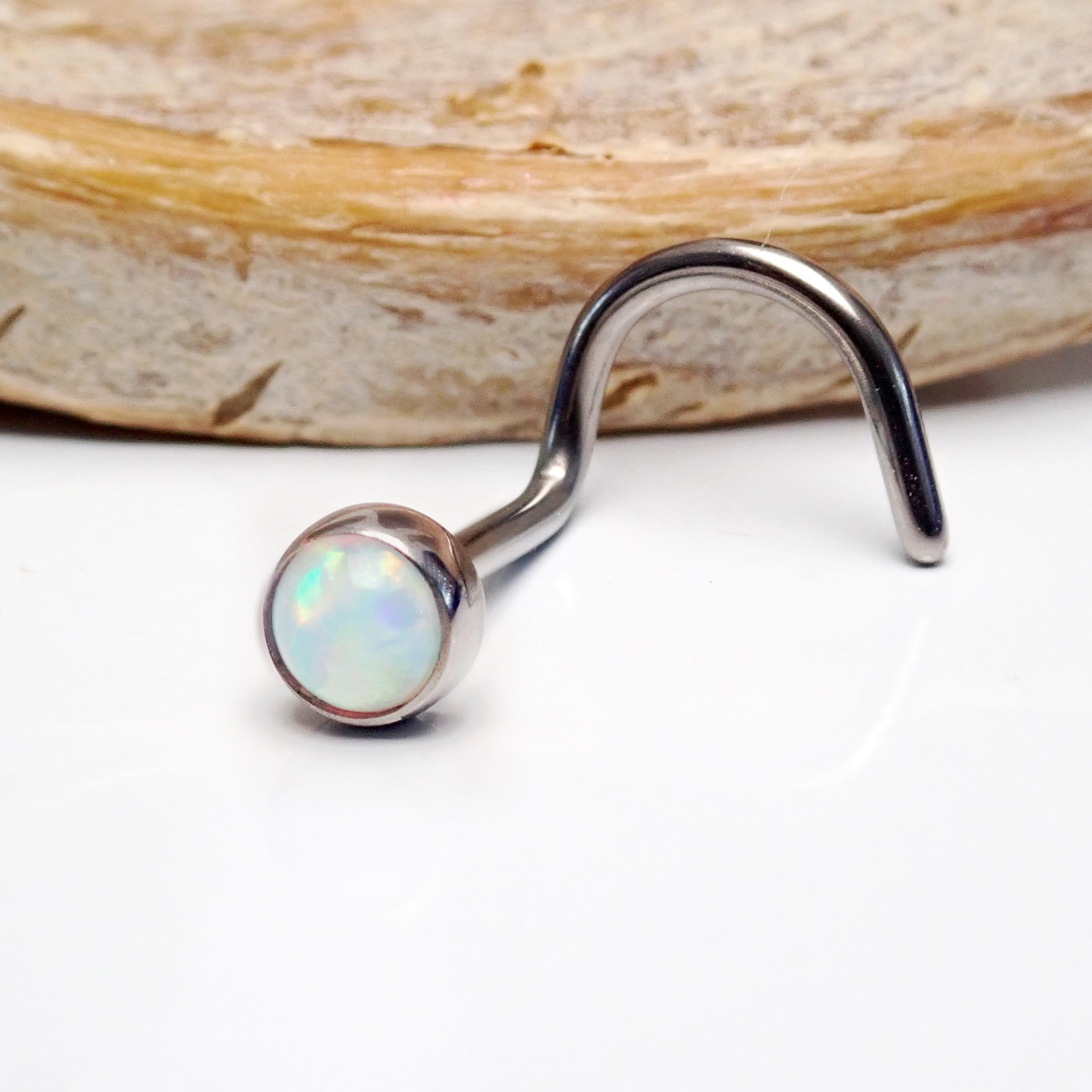 Body Clickers Opal Nose Curl body jewelry in 20g with a bubblegum pink opal design and curved shape for piercings.