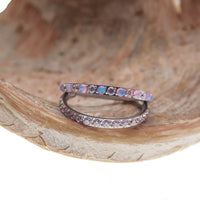 Double layer 16g split opal and CZ titanium clicker body jewelry featuring sparkling gemstones and sleek silver design.