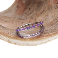 Double layer 16g split opal and CZ titanium clicker body jewelry with silver-tone finish and detailed design.