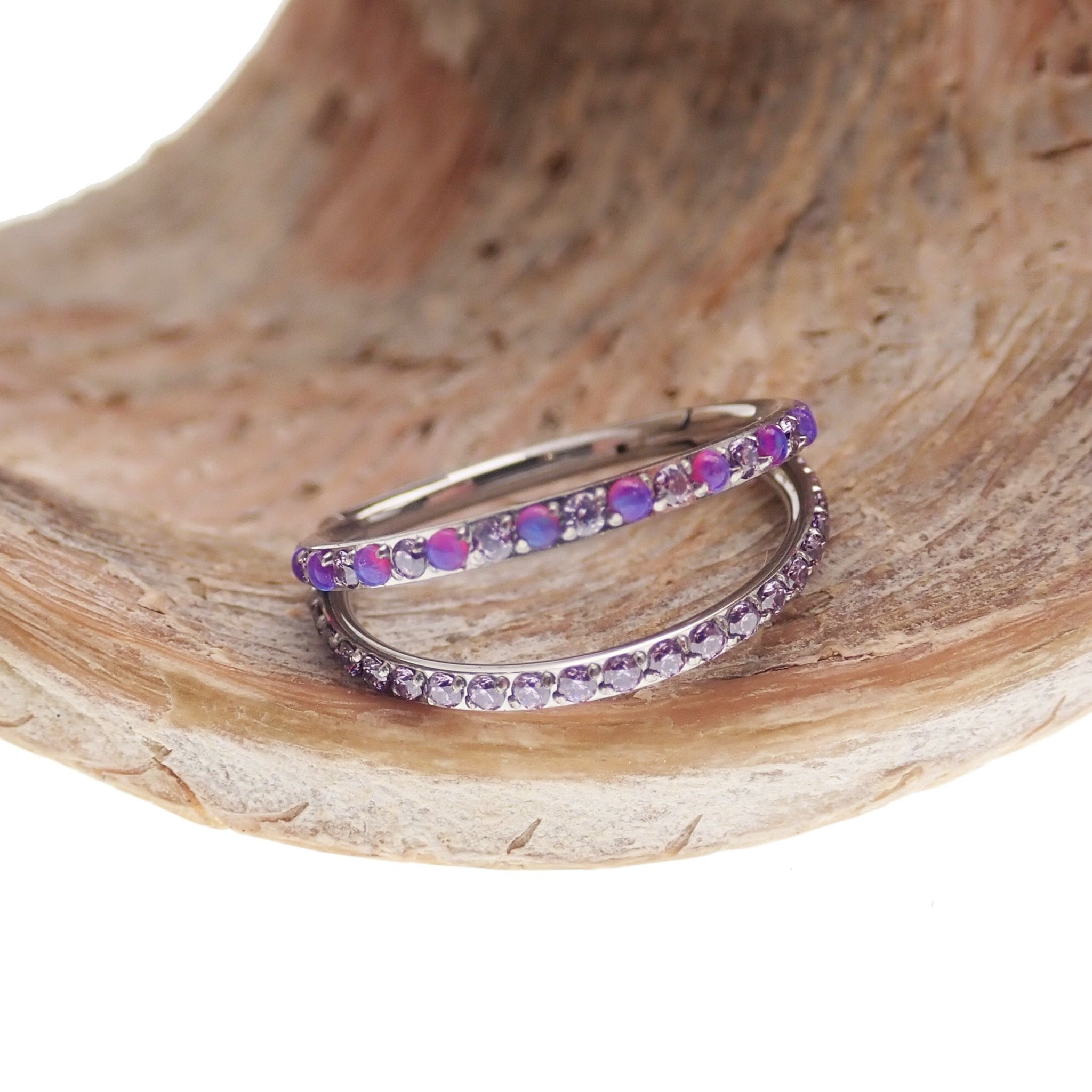 Double layer 16g split opal and CZ titanium clicker body jewelry with silver-tone finish and detailed design.