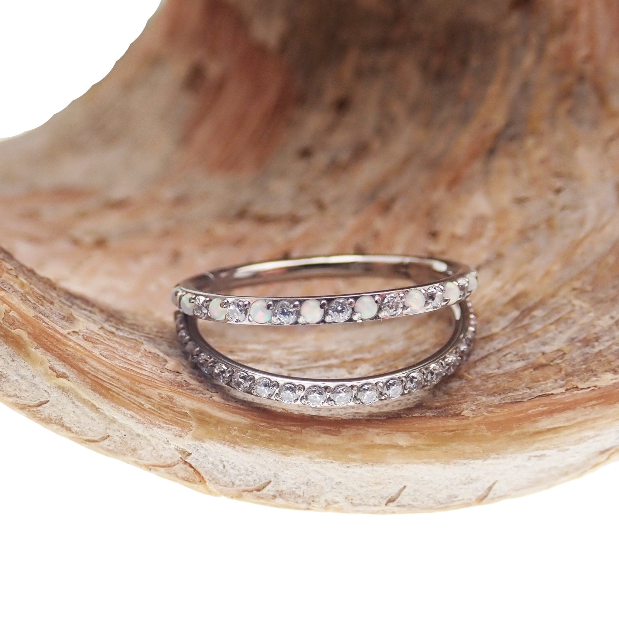 Double layer 16g split opal and cubic zirconia titanium clicker body jewelry with intricate design and secure clasp.