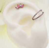 Double layer 16g split opal and CZ titanium clicker body jewelry, showcasing its elegant design and secure clicker clasp.