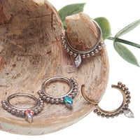Beaded teardrop clicker ring 16g body jewelry by Body Clickers, featuring colorful beads and a sleek teardrop design.