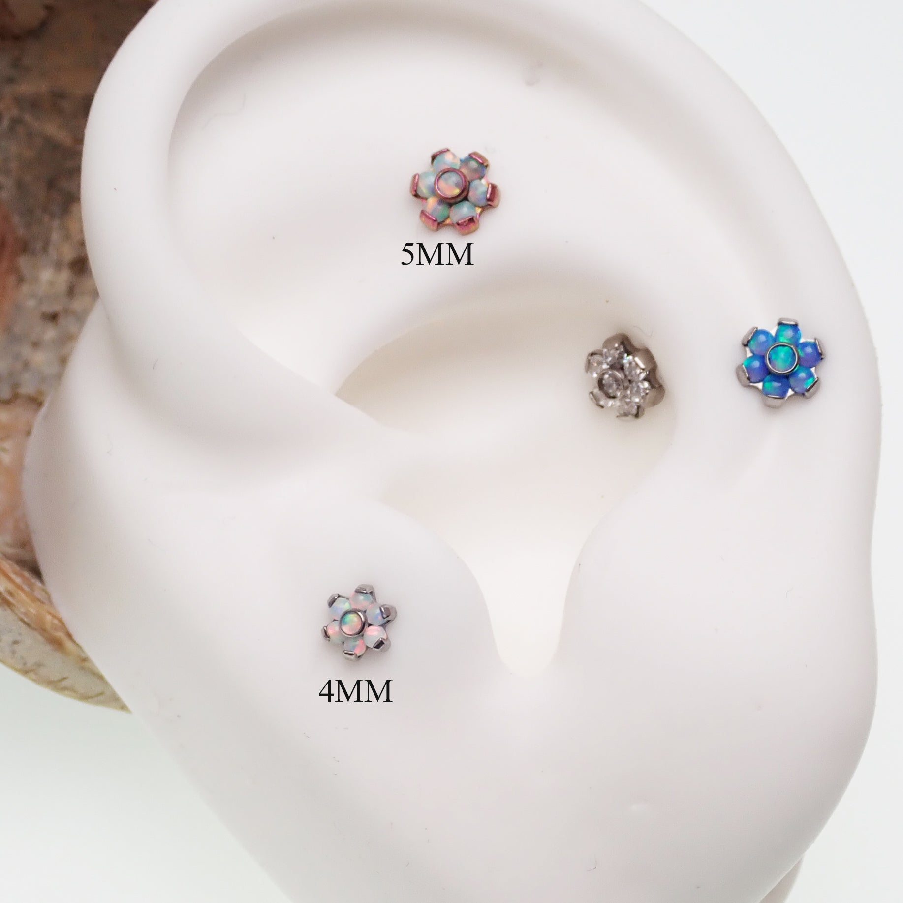 Clear CZ and opal flower push fit titanium attachments for body jewelry by Body Clickers, featuring elegant floral design.