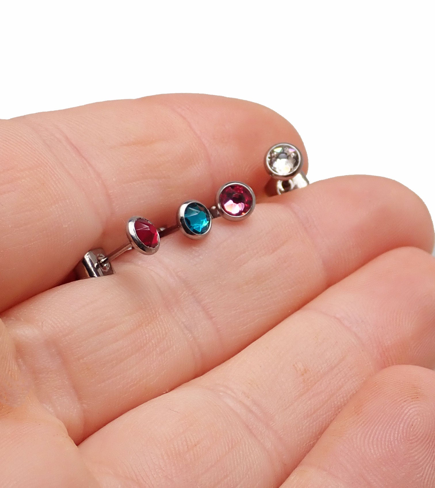 Pair of Body Clickers implant titanium CZ earrings in 20g size, clear body jewelry with sparkling cubic zirconia accents.