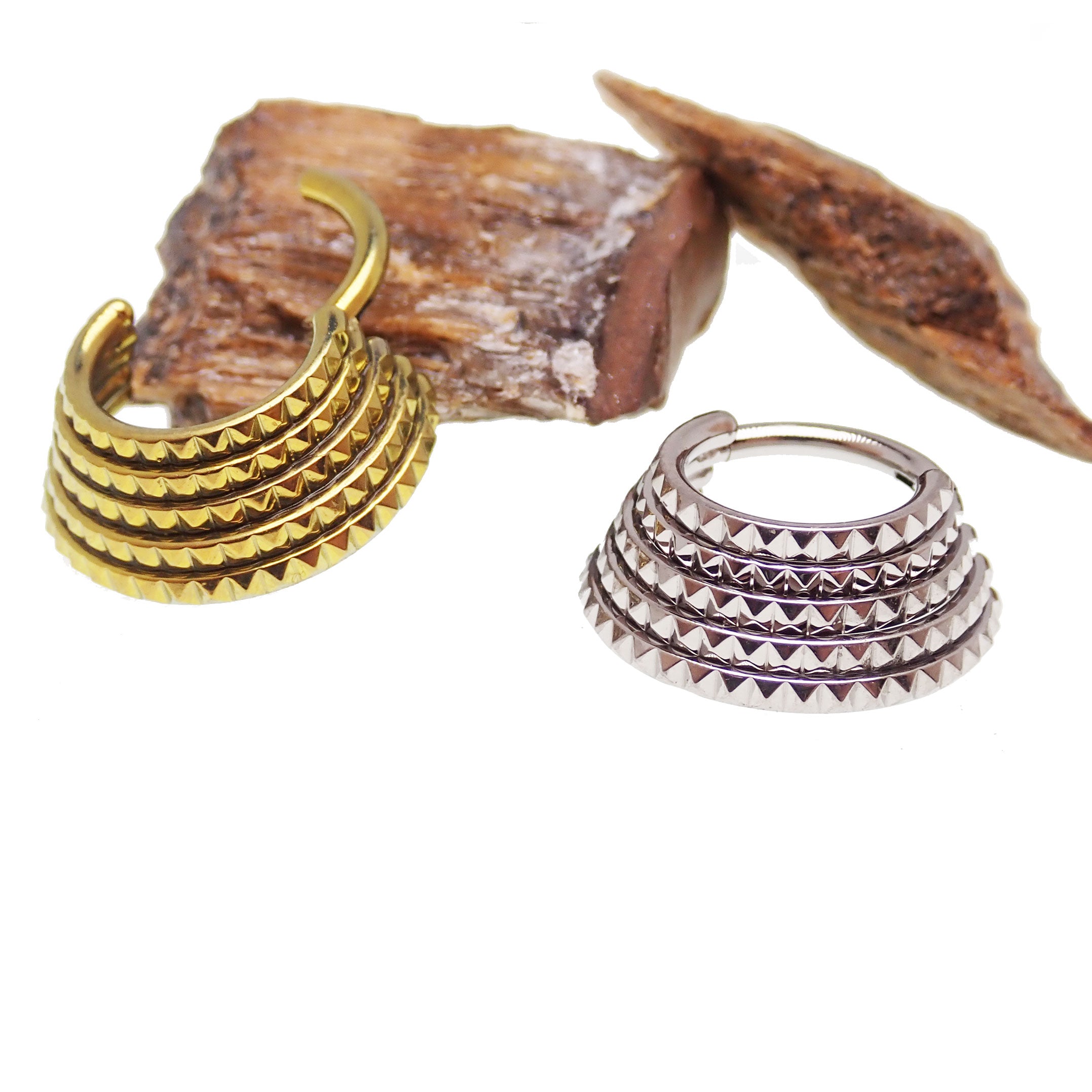 Engraved 5-tier stacked body jewelry clicker with intricate design, made by Body Clickers, showcasing multiple connected rings.