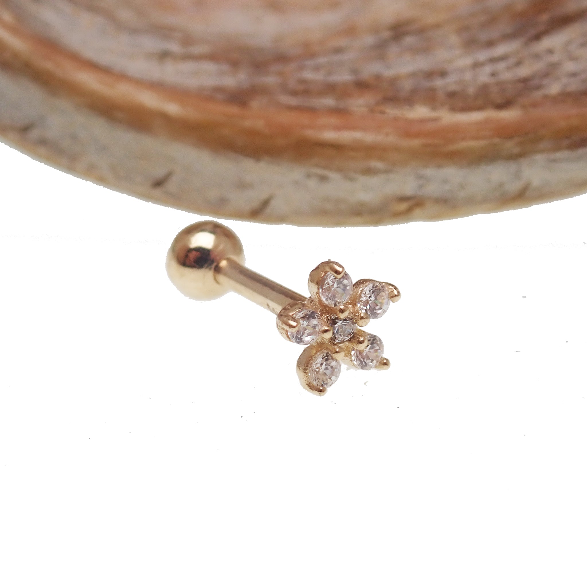 14k gold CZ flower barbell body jewelry with sparkling stones, 16g, by Body Clickers, featuring a delicate floral design.