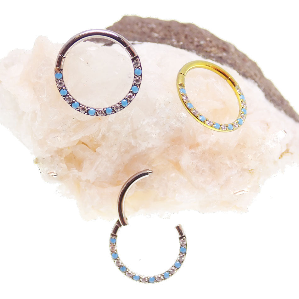 Front-facing 18g titanium clicker body jewelry with turquoise and cubic zirconia alternating stones, designed by Body Clickers.