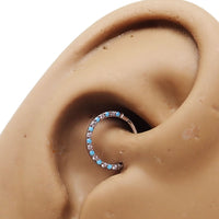 Front-facing 18g titanium clicker with turquoise and CZ stones, featuring an alternating design for body jewelry.