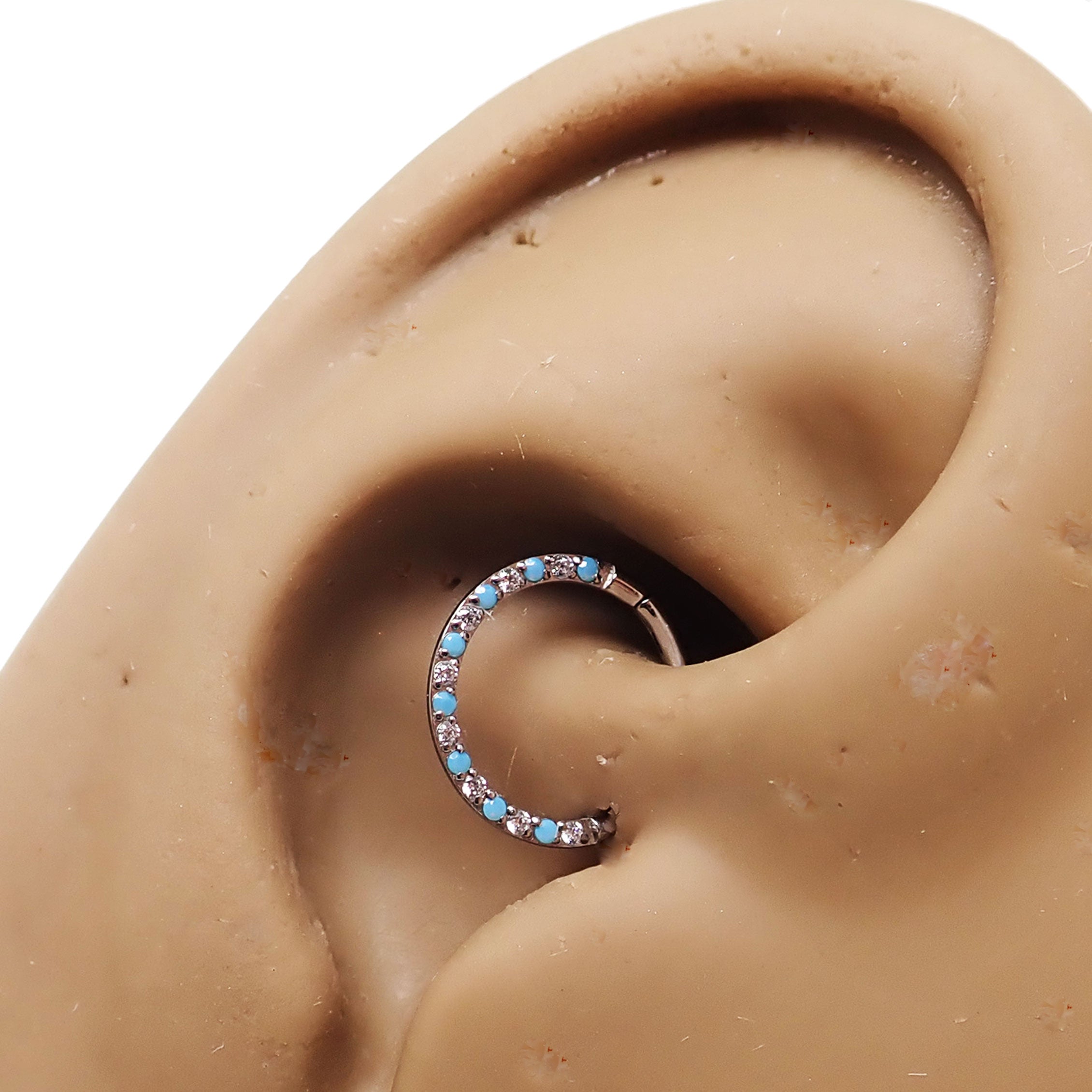 Front-facing 18g titanium clicker with turquoise and CZ stones, featuring an alternating design for body jewelry.