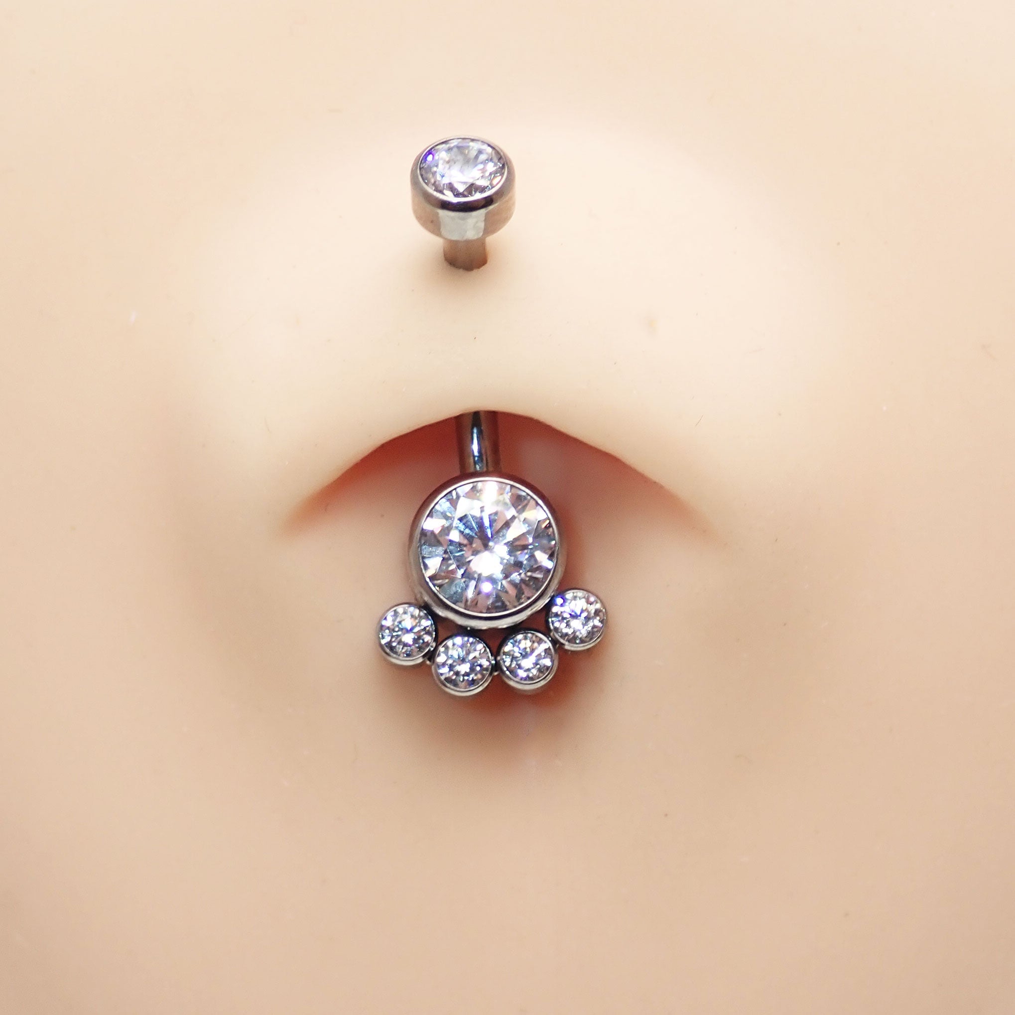Paw print clear CZ belly bar body jewelry by Body Clickers, 14g, featuring a decorative paw print design and sparkling clear stones.