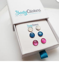 Sparkly stainless steel earrings by Body Clickers Body Jewelry featuring shiny, reflective surfaces and elegant design.