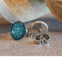 Sparkly stainless steel earrings by Body Clickers Body Jewelry featuring shiny, reflective surfaces and elegant dangle design.