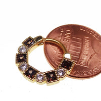 Steel clicker body jewelry with amber and clear CZ stones, 16g, featuring a sleek, lined design for fashionable body piercing.