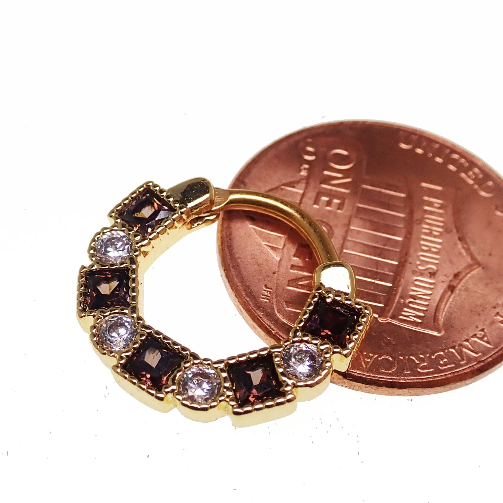 Steel clicker body jewelry with amber and clear CZ stones, 16g, featuring a sleek, lined design for fashionable body piercing.